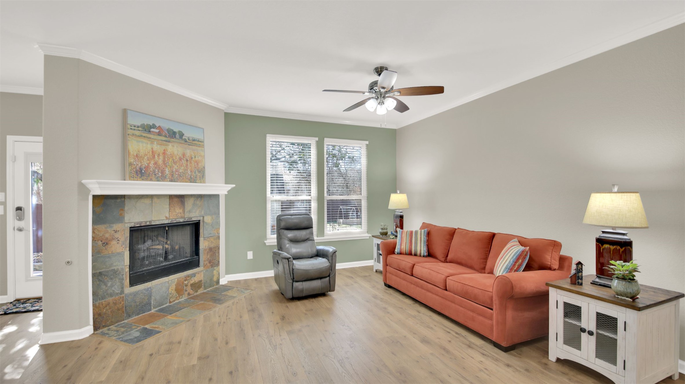 1210 Mathias Street Cedar Park, TX 78613 - Photo 4 of 31 Living area with crown molding, a fireplace, light wood-style flooring, and ceiling fan