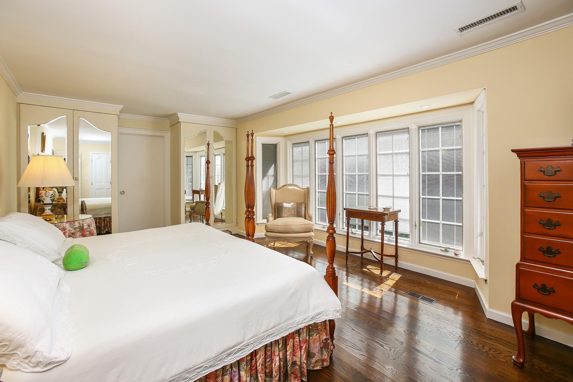 30 Old Oak Road Darien, CT 06820 - Photo 11 of 25 a bedroom with a bed a table and wooden floor