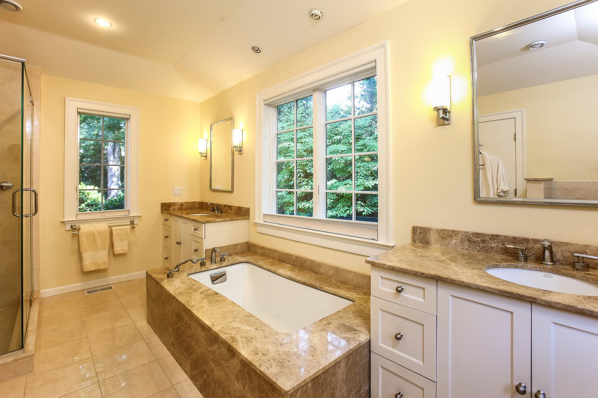 30 Old Oak Road Darien, CT 06820 - Photo 12 of 25 a spacious bathroom with a granite countertop tub sink and mirror