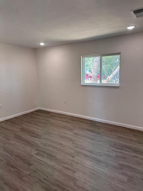 1126 East 15th Street Littlefield, TX 79339 - Photo 3 of 13 an empty room with wooden floor and windows