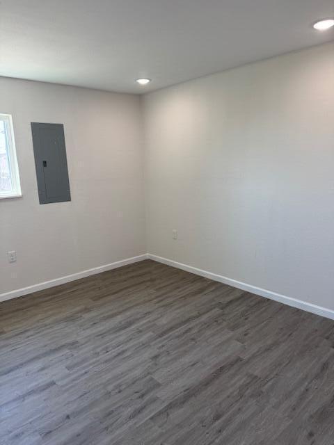 1126 East 15th Street Littlefield, TX 79339 - Photo 9 of 13 a view of an empty room with wooden floor and a window