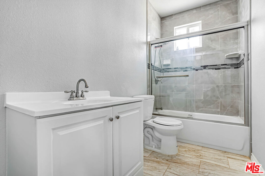 1047 West H Street Colton, CA 92324 - Photo 12 of 13 a bathroom with a sink a toilet and shower