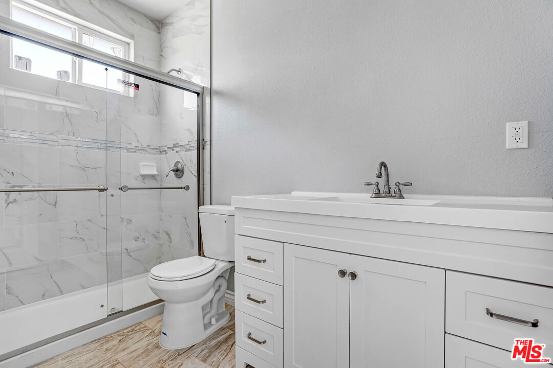 1047 West H Street Colton, CA 92324 - Photo 13 of 13 a bathroom with a sink a toilet and shower