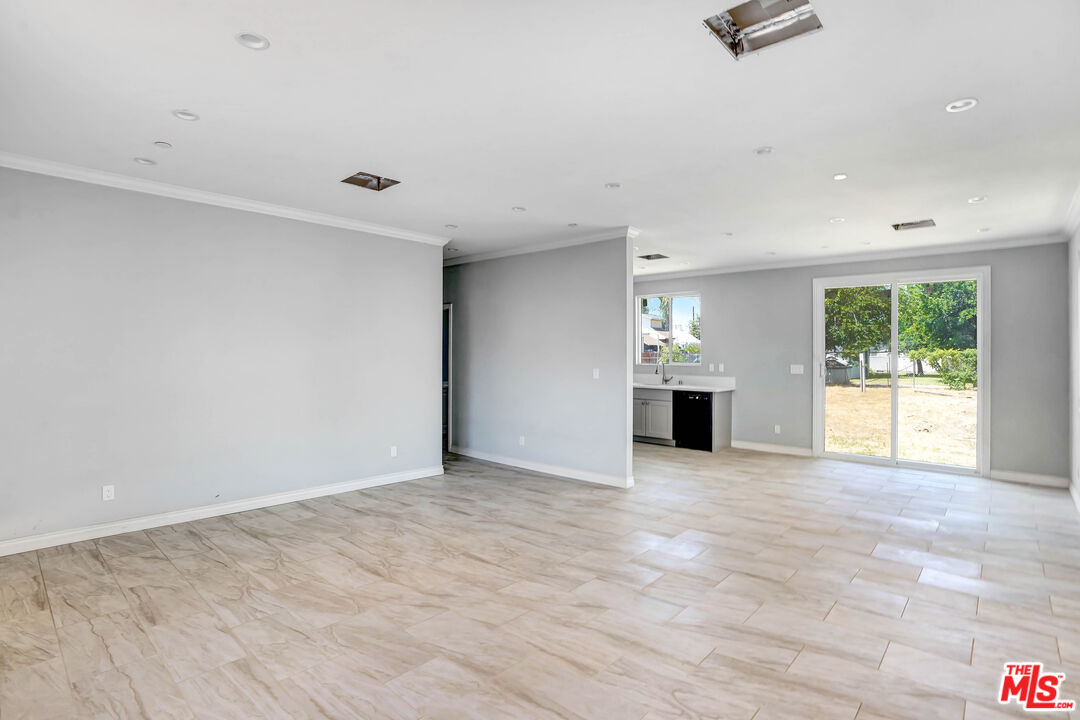 1047 West H Street Colton, CA 92324 - Photo 5 of 13 wooden floor in an empty room with a window