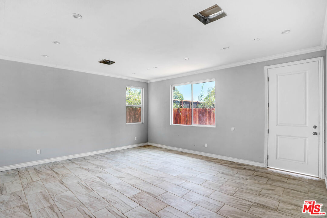1047 West H Street Colton, CA 92324 - Photo 6 of 13 wooden floor in an empty room with a window