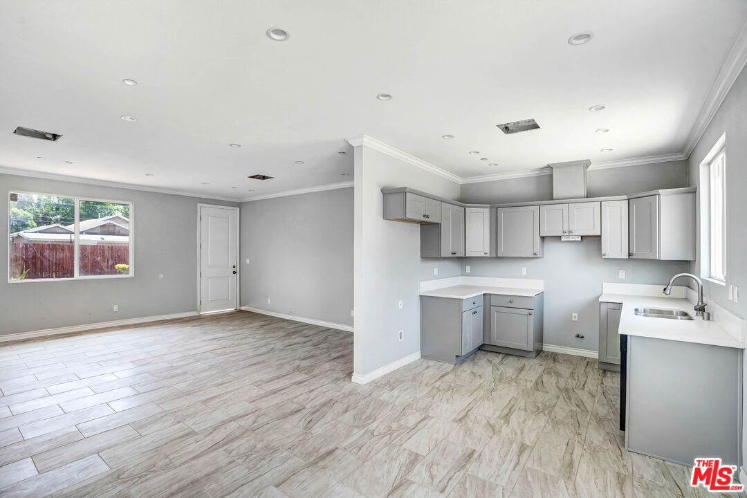 1047 West H Street Colton, CA 92324 - Photo 7 of 13 a view of a kitchen with wooden floor and electronic appliances