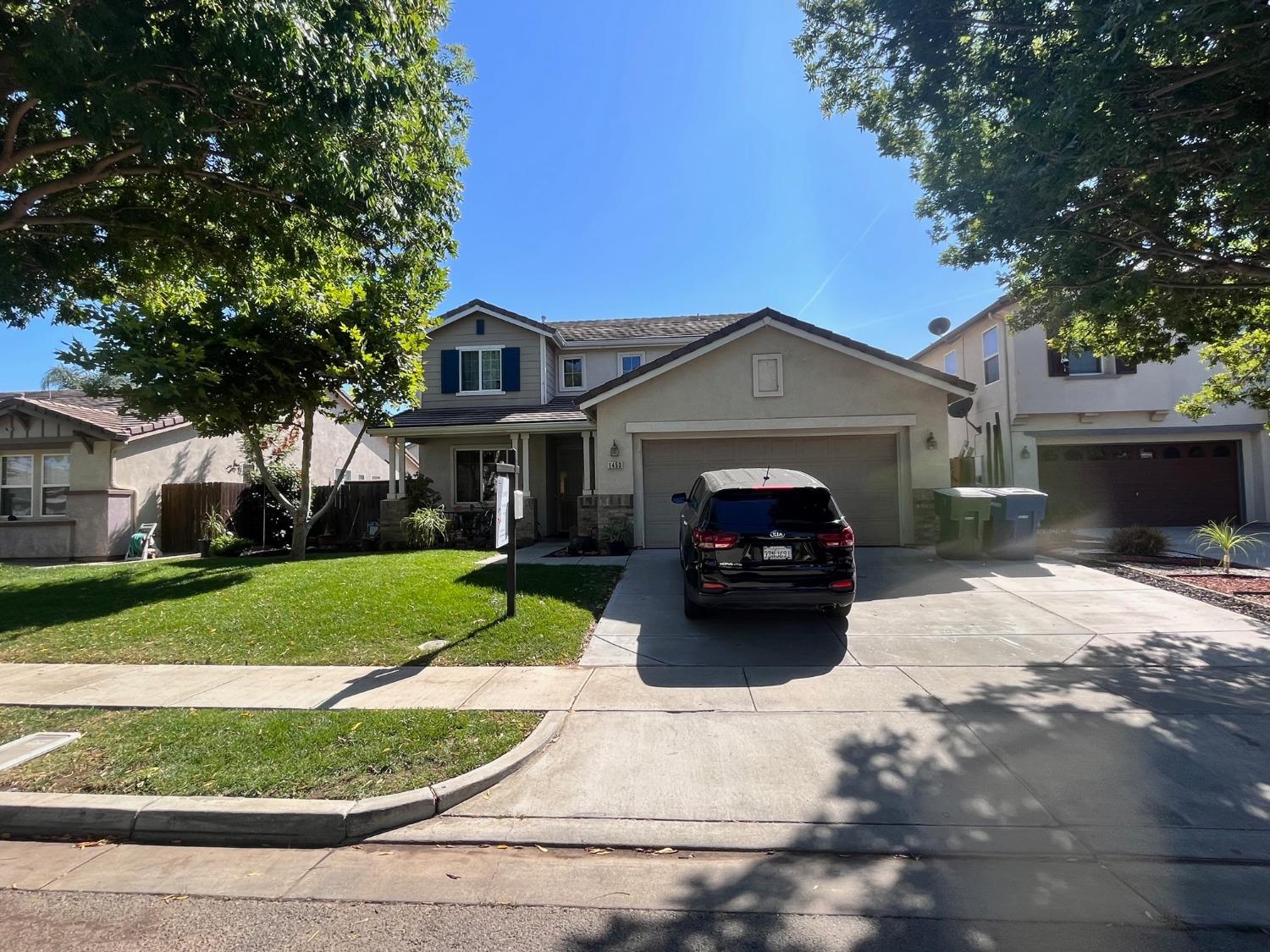1450 Longhorn Lane Patterson, CA 95363 - Photo 1 of 32 a front view of a house with a garden and pathway