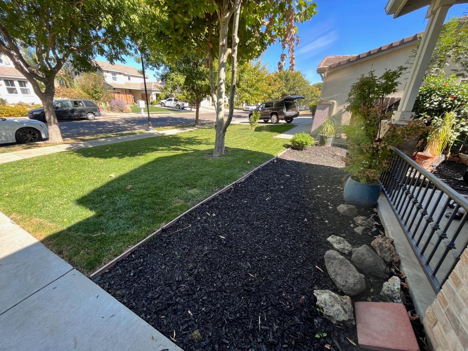1450 Longhorn Lane Patterson, CA 95363 - Photo 13 of 32 a view of a backyard with couches plants and large trees