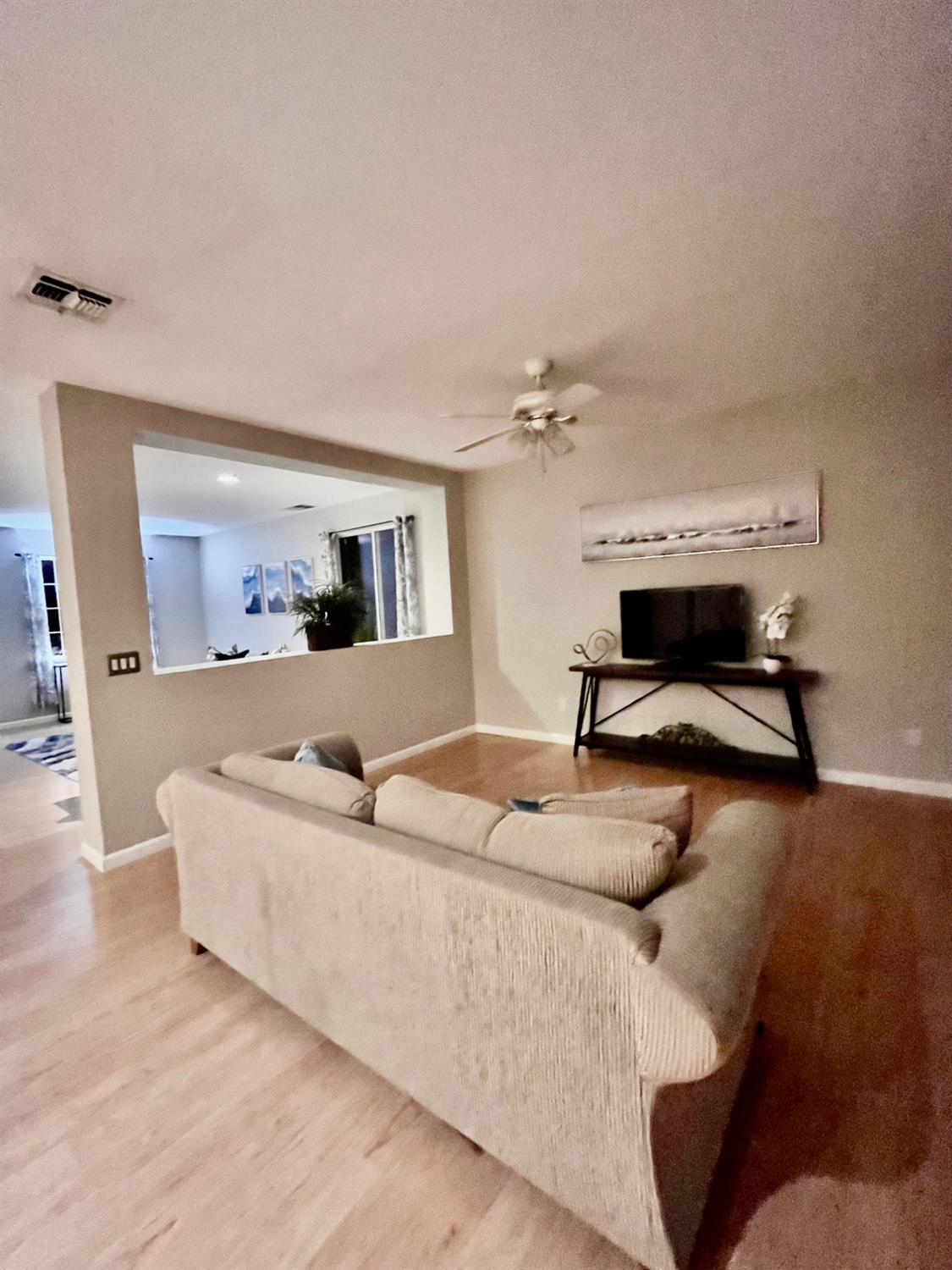 1450 Longhorn Lane Patterson, CA 95363 - Photo 21 of 32 a living room with furniture and a wooden floor