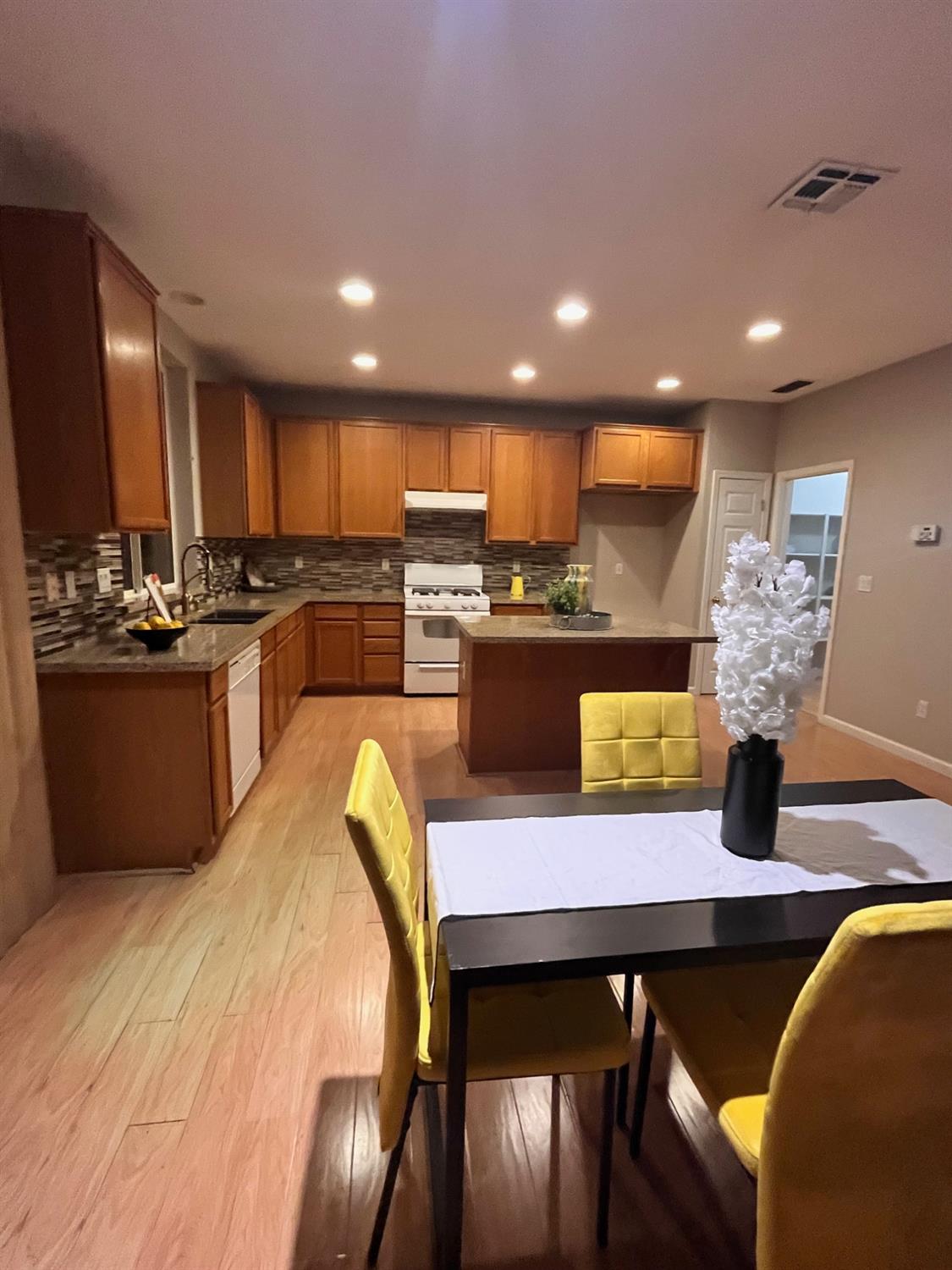 1450 Longhorn Lane Patterson, CA 95363 - Photo 30 of 32 a large kitchen with a table and chairs