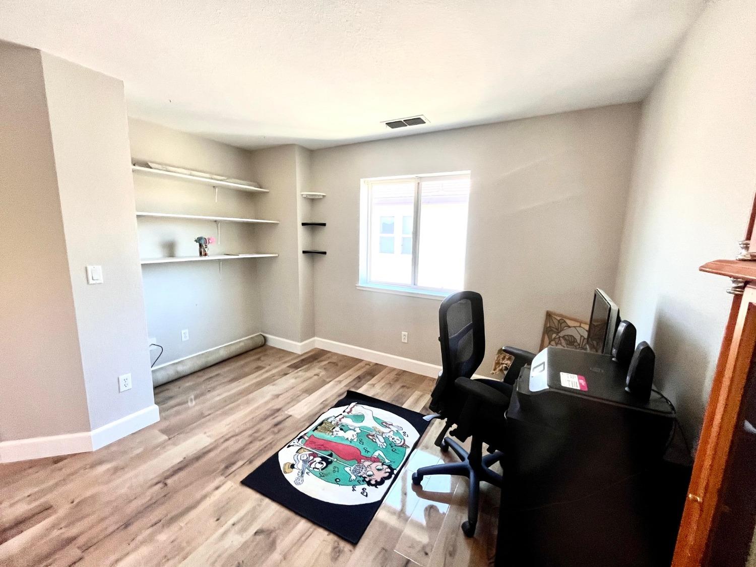 1450 Longhorn Lane Patterson, CA 95363 - Photo 4 of 32 a view of a workspace with furniture and toys