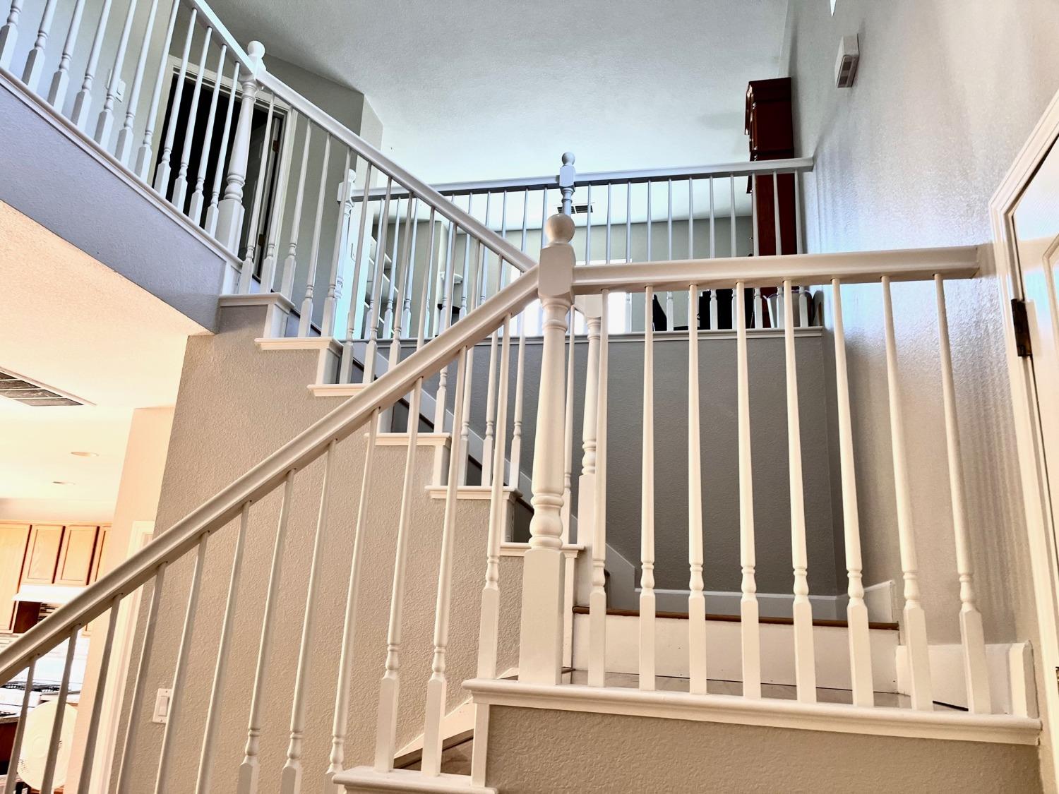1450 Longhorn Lane Patterson, CA 95363 - Photo 9 of 32 a view of staircase with wooden floor and white walls