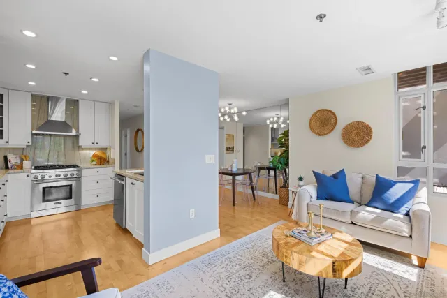 a living room with furniture and kitchen view
