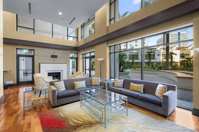 a front view of a building with swimming pool and outdoor seating