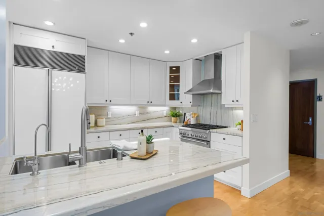 a kitchen with kitchen island a sink appliances and cabinets