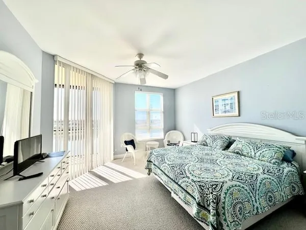 a bathroom with a tub a sink and glass door