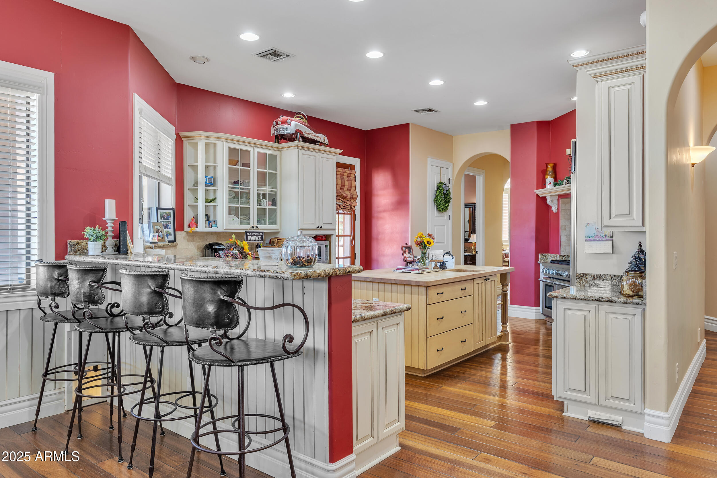 7172 Gelding Lane Coolidge, AZ 85128 - Photo 11 of 45 a kitchen with stainless steel appliances kitchen island granite countertop a stove a sink and white cabinets with wooden floor