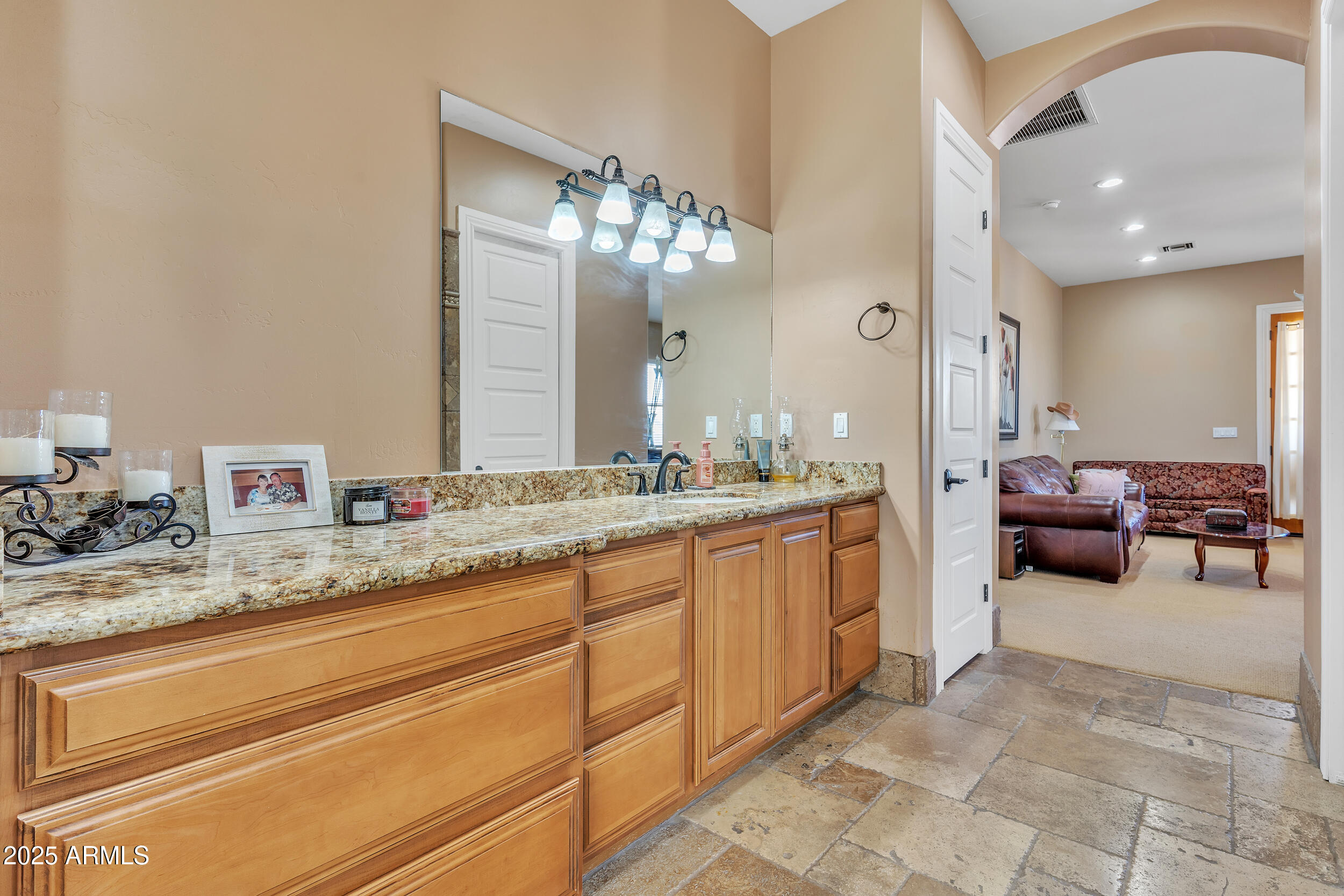 7172 Gelding Lane Coolidge, AZ 85128 - Photo 24 of 45 a spacious bathroom with a granite countertop sink a mirror and a vanity