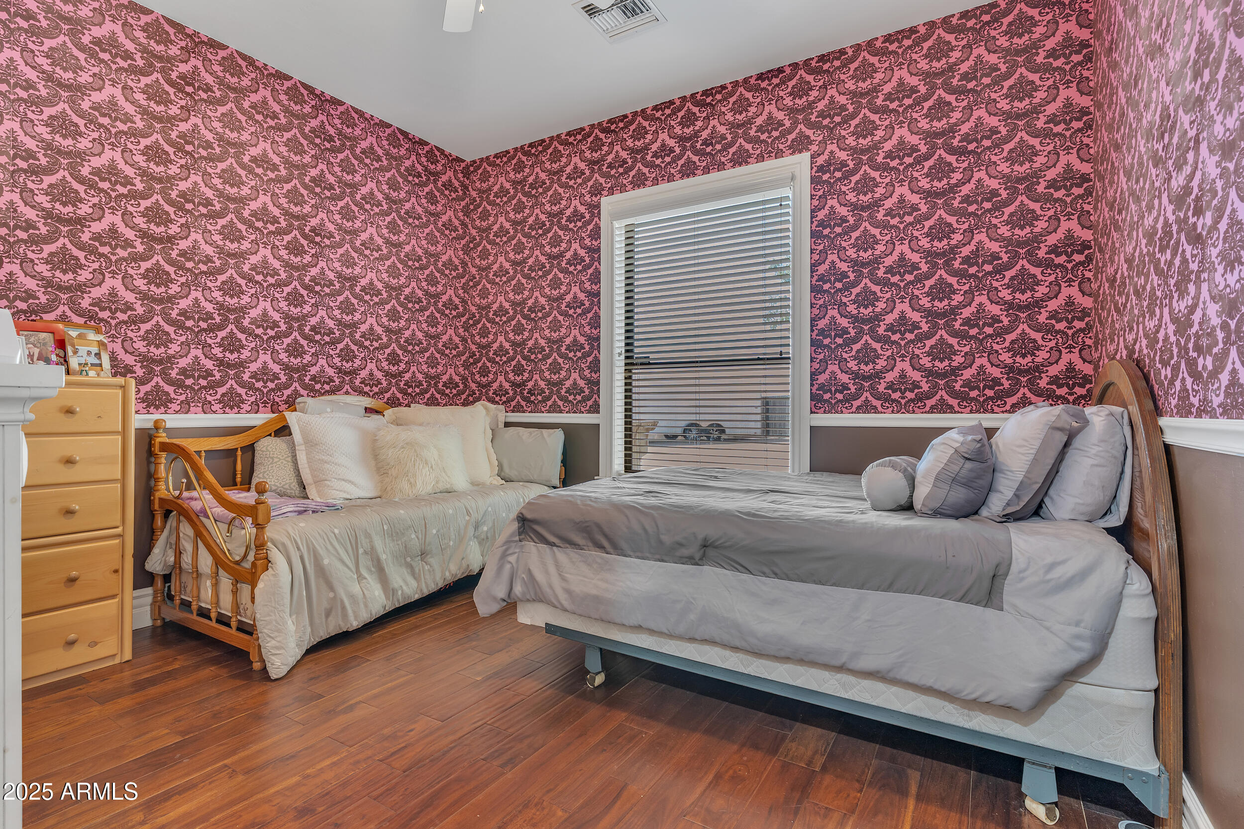 7172 Gelding Lane Coolidge, AZ 85128 - Photo 27 of 45 a bedroom with a bed lamp and a fireplace