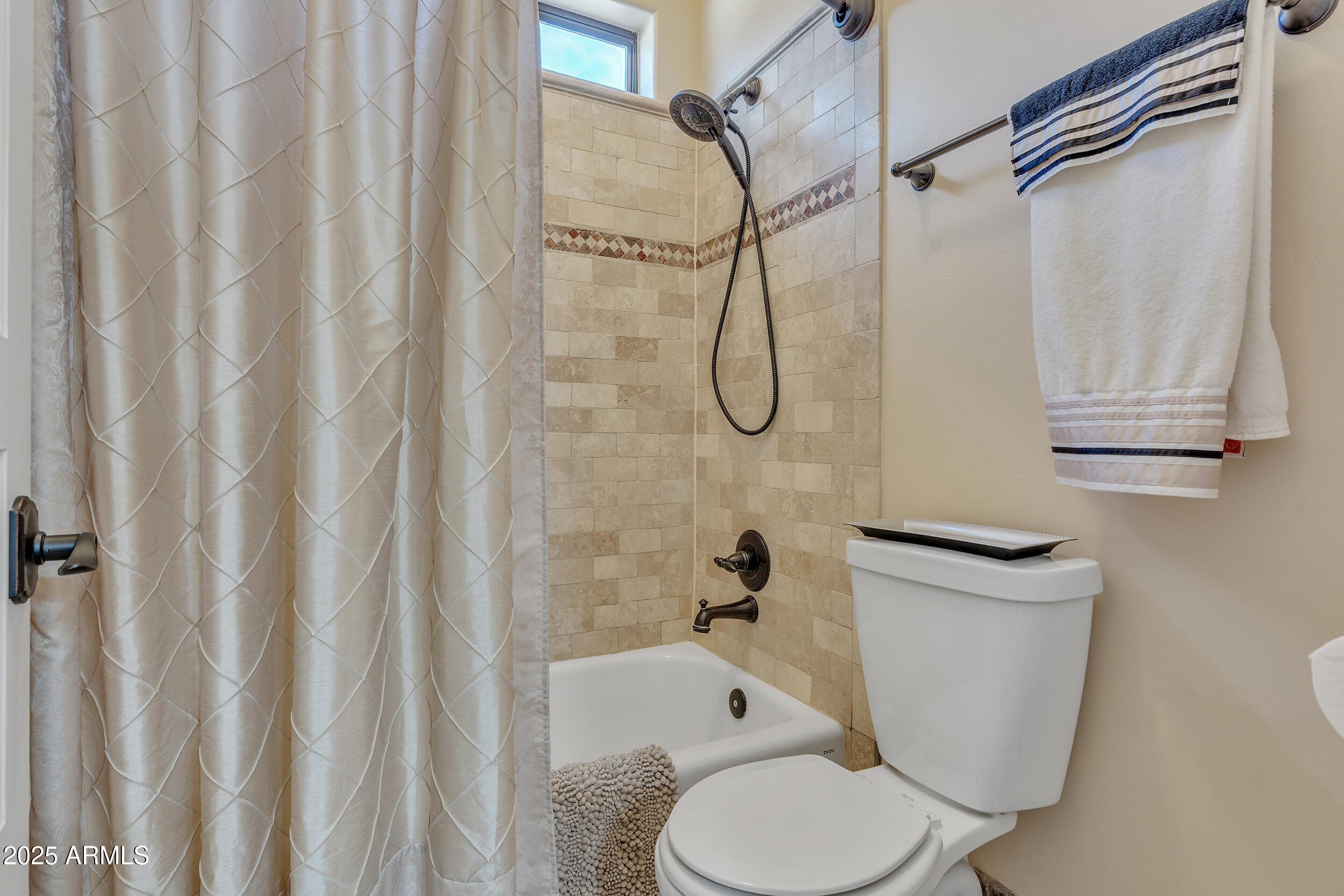 7172 Gelding Lane Coolidge, AZ 85128 - Photo 30 of 45 a white toilet sitting next to a bath tub curtain