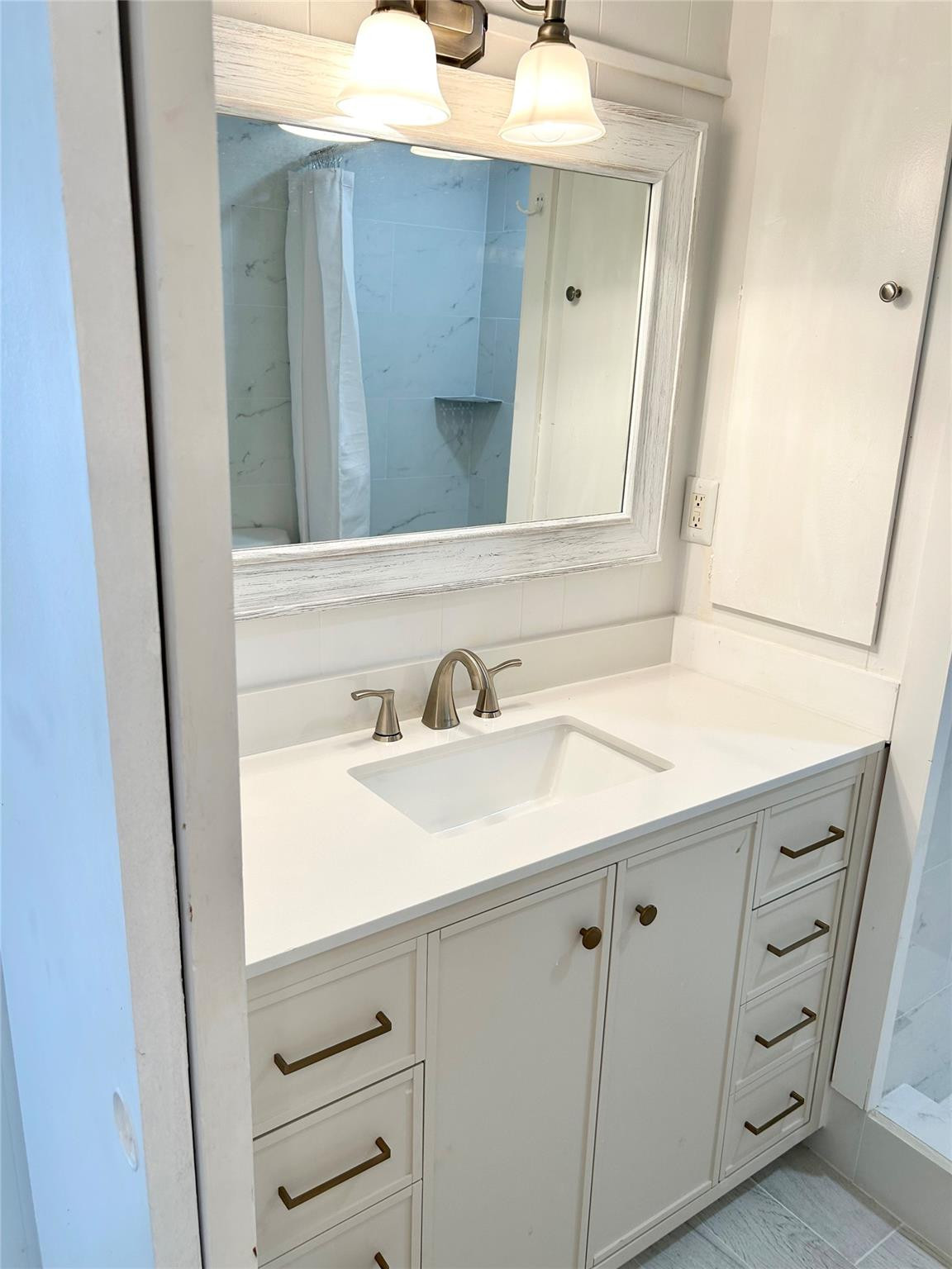 5400 Southeast Jack Avenue Stuart, FL 34997 - Photo 13 of 20 a bathroom with a sink and a mirror