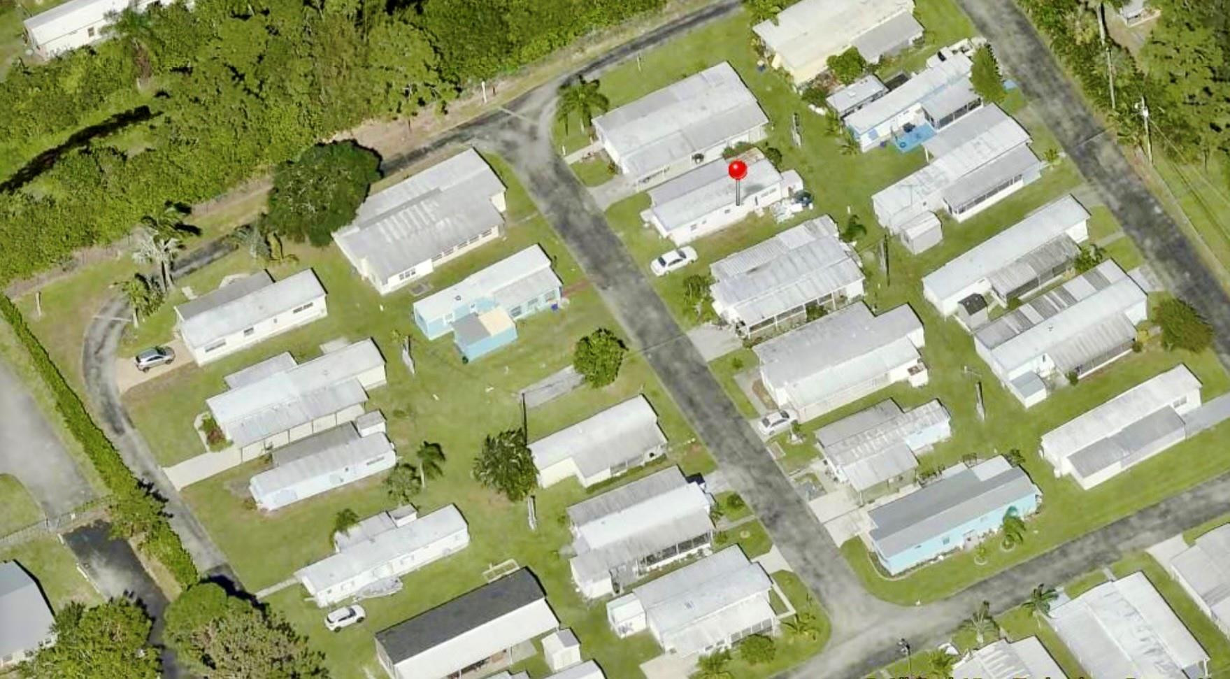 5400 Southeast Jack Avenue Stuart, FL 34997 - Photo 15 of 20 an aerial view of a residential apartment building with swimming pool