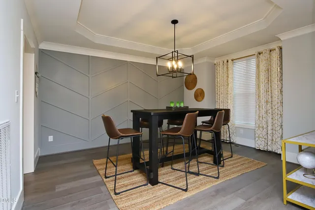a view of a dining room with furniture wooden floor and chandelier
