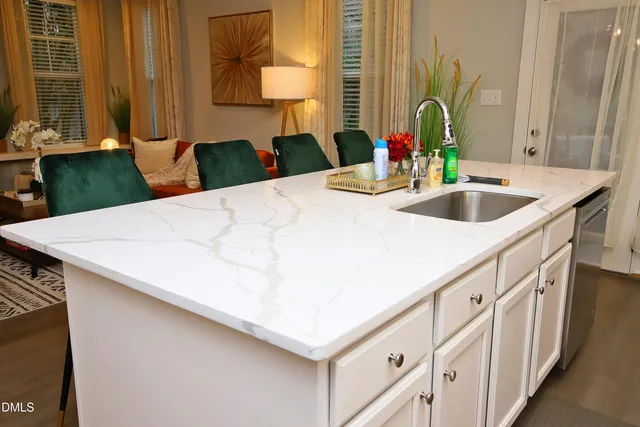 a kitchen with stainless steel appliances granite countertop a sink a stove and a refrigerator