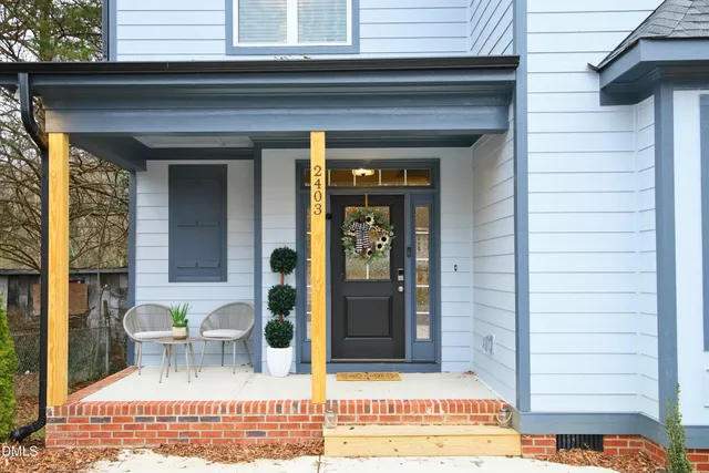 a view of a house with backyard and deck