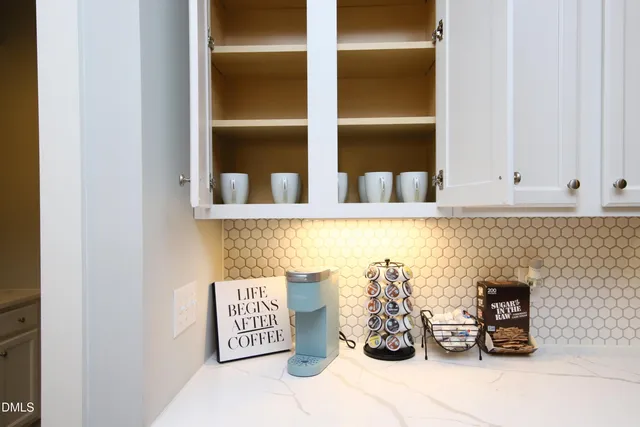 a large bed sitting in a bedroom next to a window and a chair
