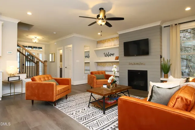 a living room with furniture ceiling fan and a rug