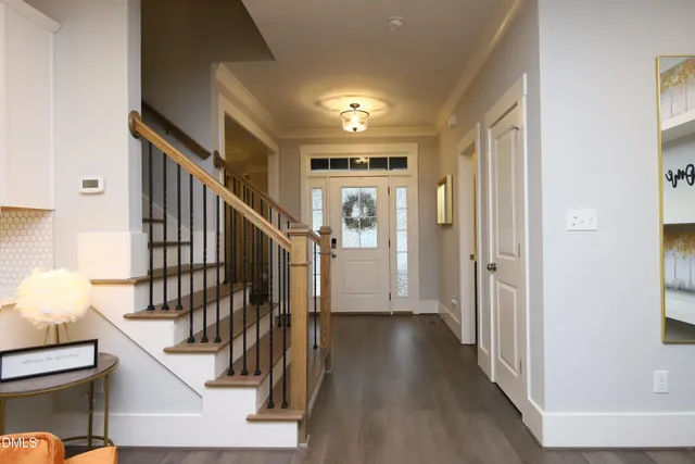 a living room with furniture kitchen view and a chandelier