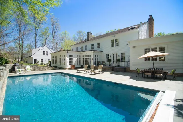 a swimming pool with outdoor seating and yard
