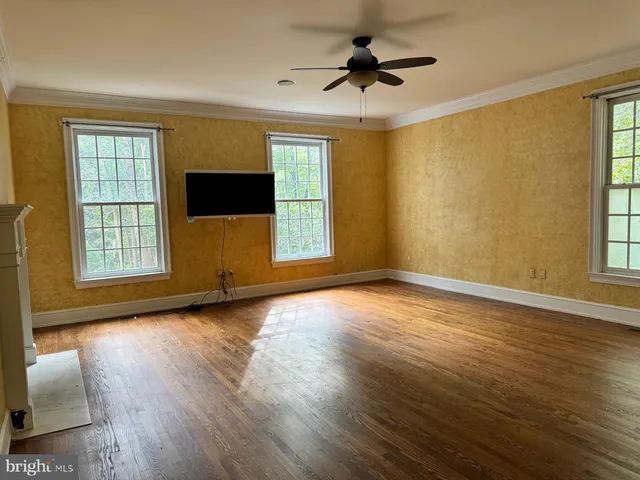 a spacious bathroom with a tub and large windows