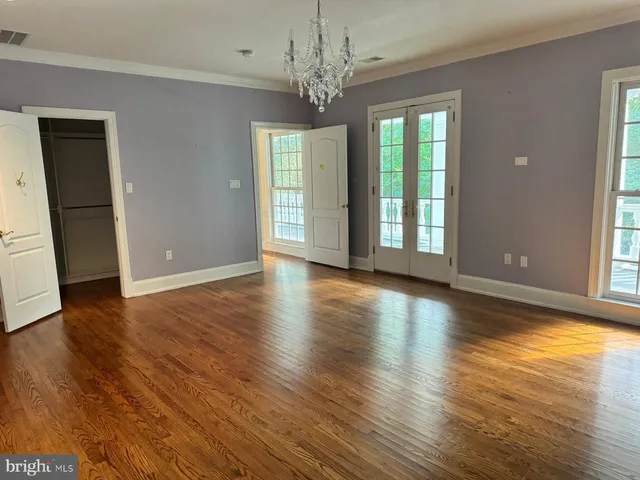 a view of an empty room with a staircase