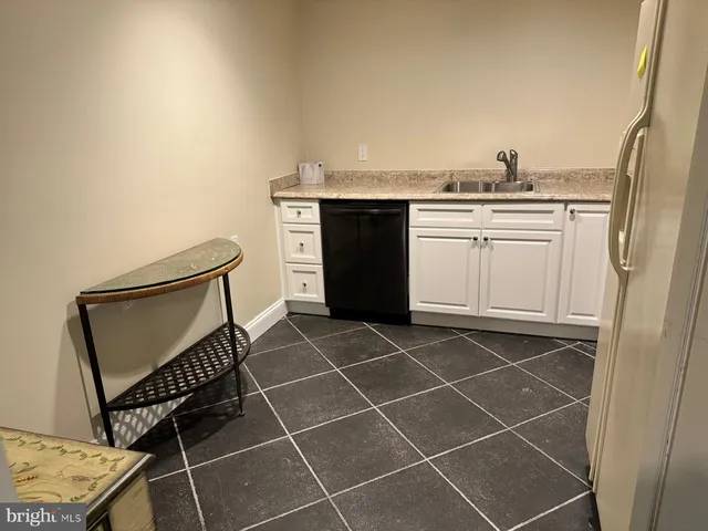 a kitchen with a sink cabinets and window