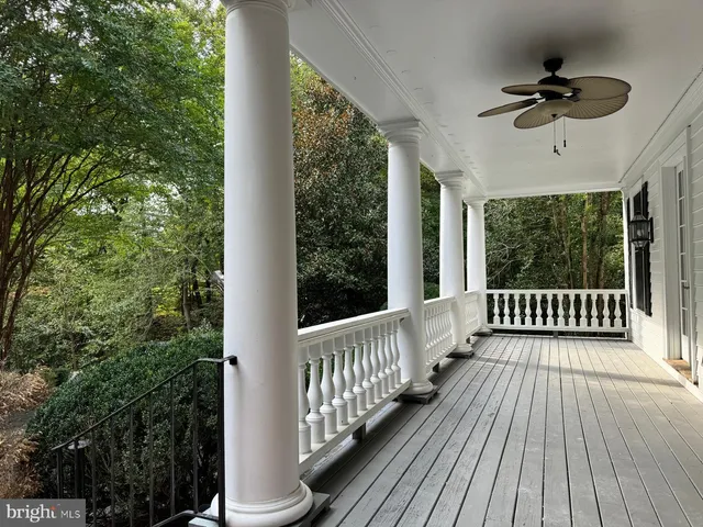 a view of a porch with wooden floor and outdoor seating