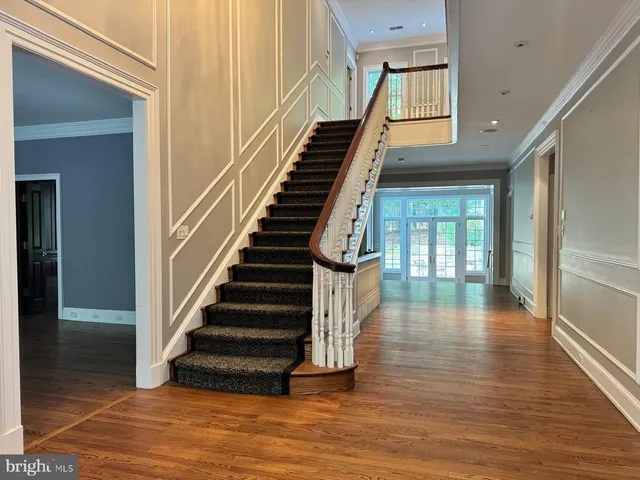 a large kitchen with stainless steel appliances a refrigerator and a stove top oven