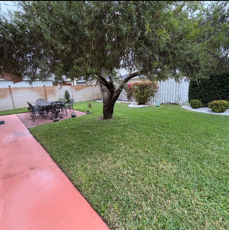 3111 Thames Way Miramar, FL 33025 - Photo 18 of 18 a backyard of a house with table and chairs