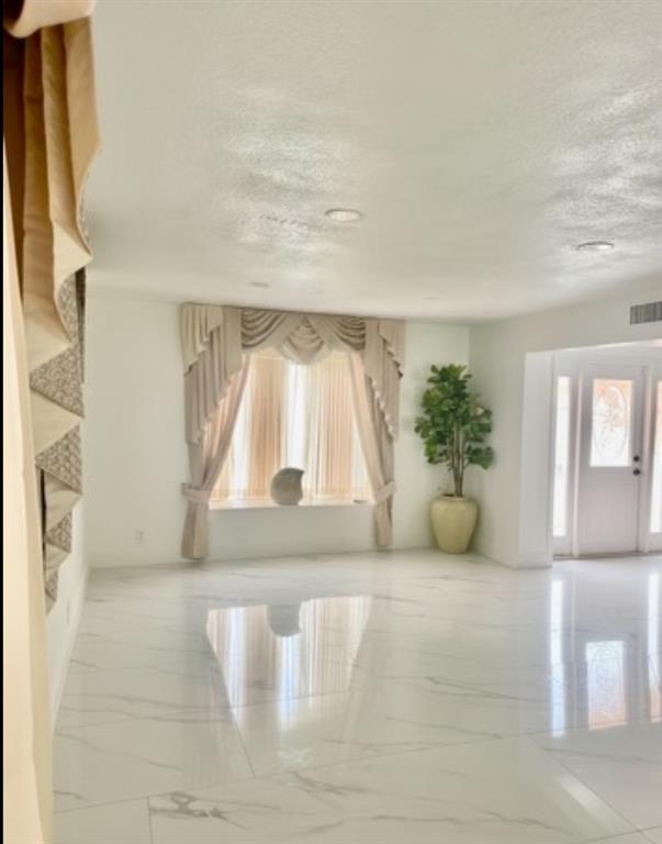 3111 Thames Way Miramar, FL 33025 - Photo 6 of 18 a view of empty room with wooden floor and fan