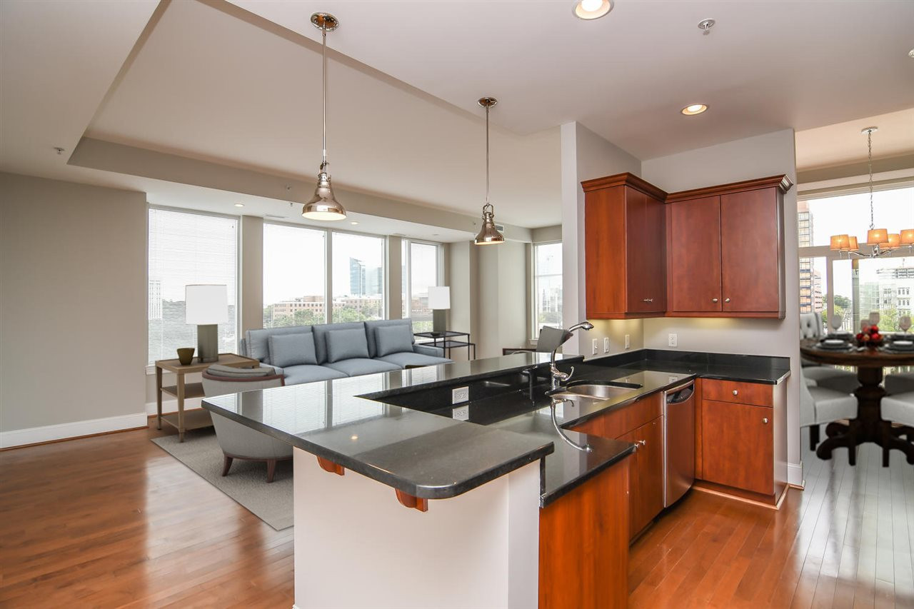 400 West North Street, Unit 830 Raleigh, NC 27603 - Photo 9 of 25 Looking out to the family room with a raised breakfast bar Chef's Kitchen