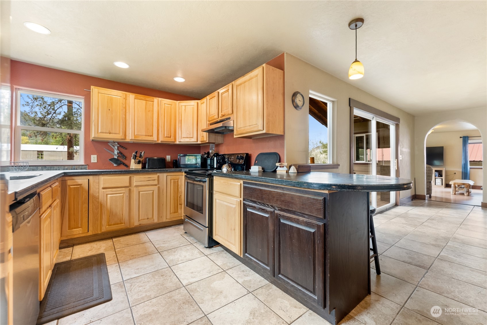 36 Twisp Airport Road Twisp, WA 98856 - Photo 18 of 38 a kitchen with stainless steel appliances granite countertop a stove sink and cabinets