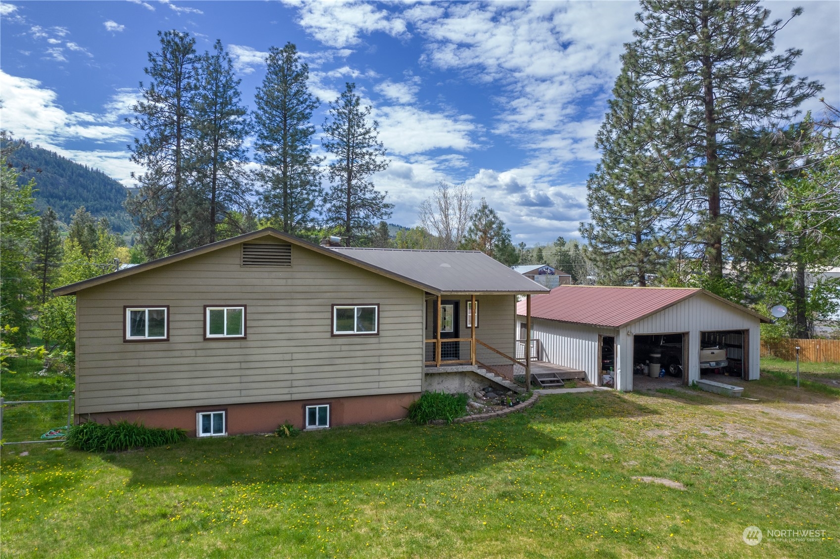 36 Twisp Airport Road Twisp, WA 98856 - Photo 3 of 38 a front view of a house with yard and green space