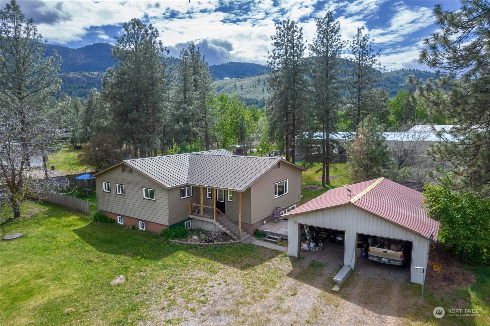 36 Twisp Airport Road Twisp, WA 98856 - Photo 38 of 38 a aerial view of a house with a yard table and chairs