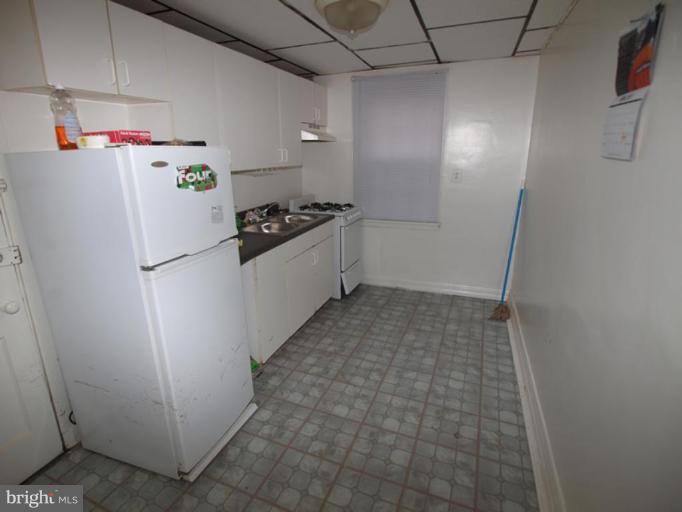 2829 Round Road Baltimore, MD 21225 - Photo 2 of 11 a kitchen with a refrigerator and a stove