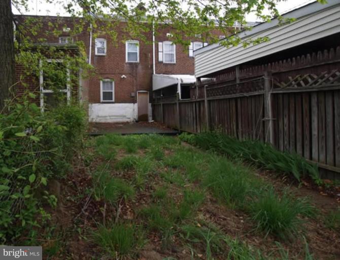 2829 Round Road Baltimore, MD 21225 - Photo 5 of 11 a view of backyard with potted plants and wooden fence