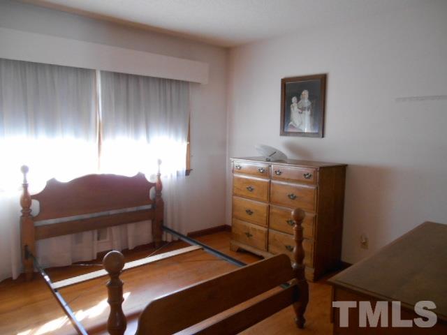 6591 Dwight Rowland Road Willow Spring, NC 27592 - Photo 14 of 16 a room with furniture and screen