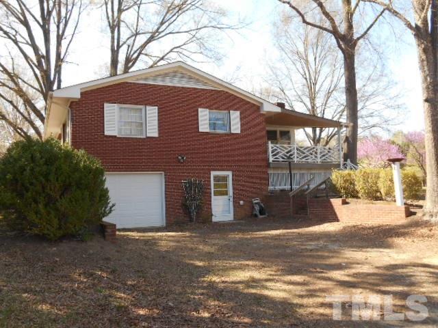 6591 Dwight Rowland Road Willow Spring, NC 27592 - Photo 4 of 16 a view of a house with a yard