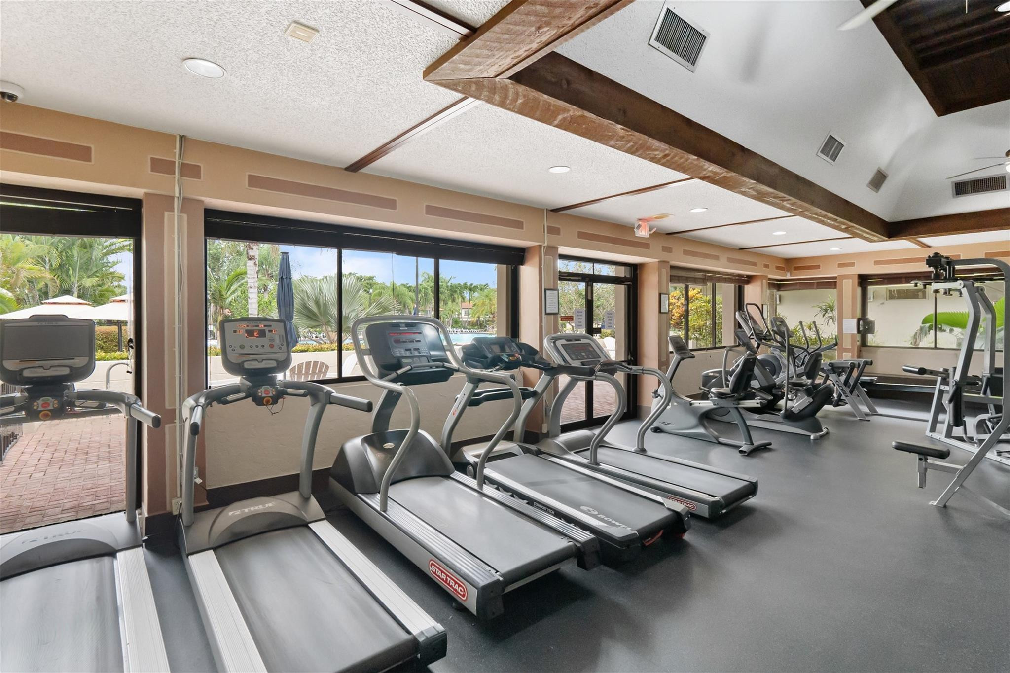 13278 Southwest 114th Terrace, Unit 13278 Miami, FL 33186 - Photo 24 of 35 a living room with lots of glass windows