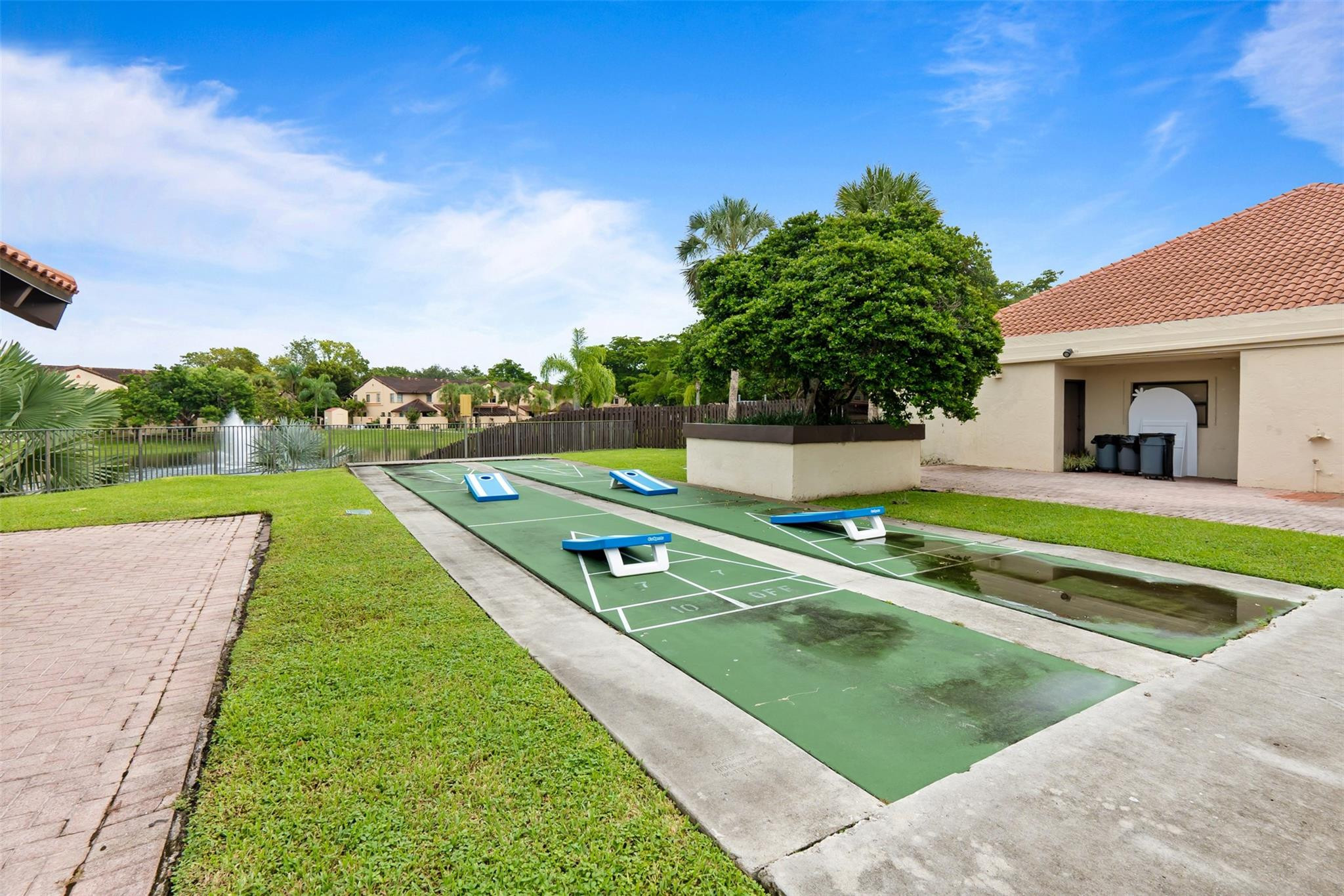 13278 Southwest 114th Terrace, Unit 13278 Miami, FL 33186 - Photo 32 of 35 a view of a house with a big yard potted plants and a palm tree